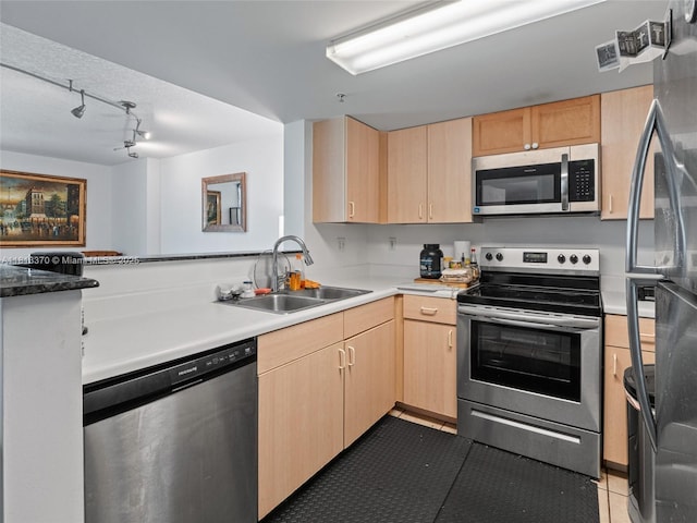 3000 Coral Way Unit 815, Miami, FL 33145 - kitchen featuring appliances with stainless steel finishes, light brown cabinetry, track lighting, and tile patterned floors