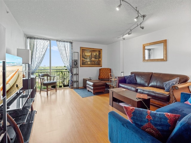3000 Coral Way Unit 815, Miami, FL 33145 - living room featuring wood finished floors, a textured ceiling, and floor to ceiling windows