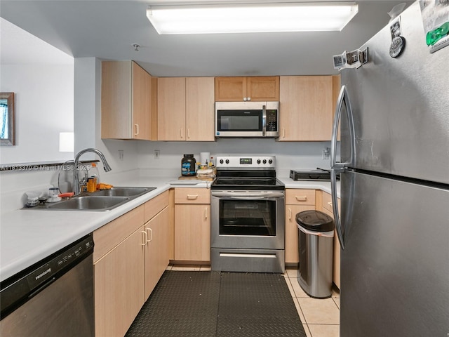 3000 Coral Way Unit 815, Miami, FL 33145 - kitchen featuring stainless steel appliances, light brown cabinets, light countertops, and light tile patterned floors