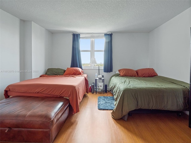 3000 Coral Way Unit 815, Miami, FL 33145 - bedroom featuring light wood-style floors and a textured ceiling