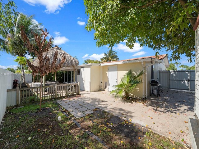 1715 SW 102nd Ct, Miami, FL 33165 - back of property with stucco siding, a gate, a fenced backyard, and a patio