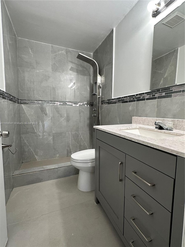 8600 SW 12th St, Pembroke Pines, FL 33025 - full bath featuring tile walls, vanity, a tile shower, and toilet