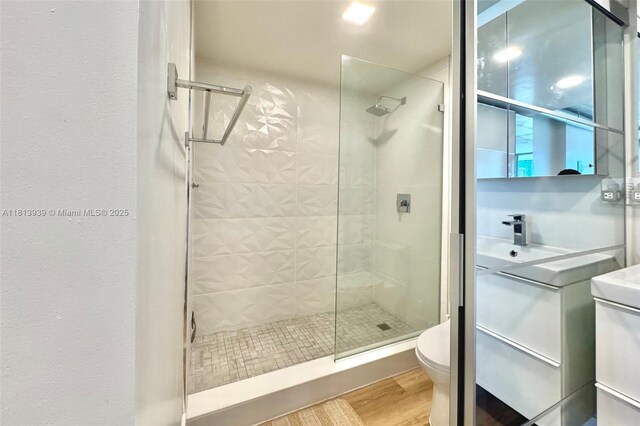 690 SW 1st Ct Unit 1006, Miami, FL 33130 - bathroom featuring toilet, a stall shower, wood finished floors, and vanity