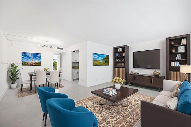 13455 SW 9th Ct Unit 315J, Pembroke Pines, FL 33027 - living area with a chandelier, built in shelves, and baseboards