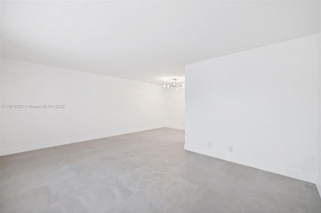 13455 SW 9th Ct Unit 315J, Pembroke Pines, FL 33027 - unfurnished room with baseboards and a chandelier