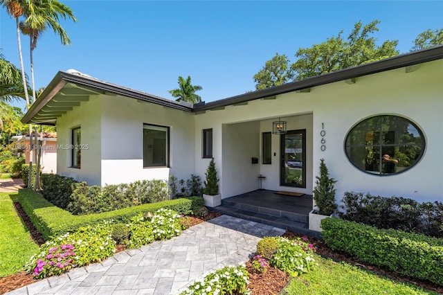 1060 NE 95th St, Miami Shores, FL 33138 - doorway to property featuring stucco siding and covered porch