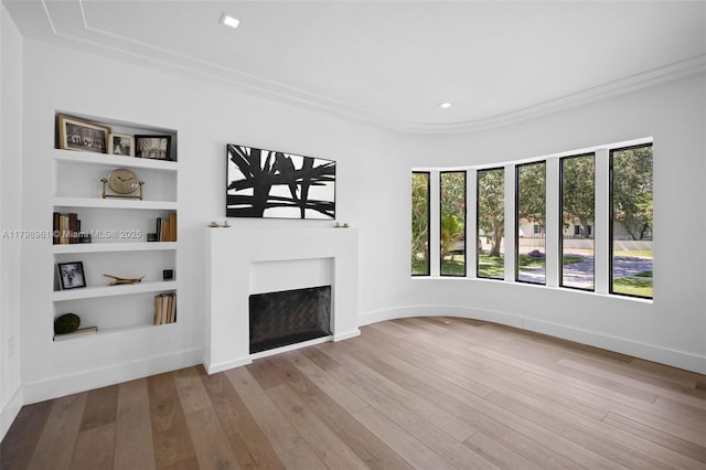 1060 NE 95th St, Miami Shores, FL 33138 - unfurnished living room with a fireplace, wood finished floors, built in shelves, ornamental molding, and recessed lighting