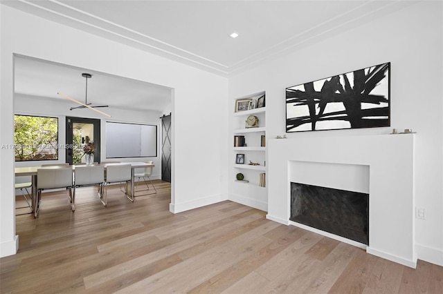 1060 NE 95th St, Miami Shores, FL 33138 - unfurnished living room featuring built in features, a fireplace, wood finished floors, recessed lighting, and an office area