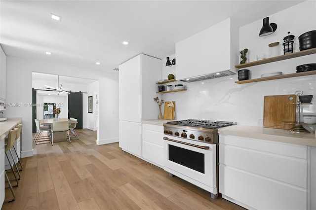 1060 NE 95th St, Miami Shores, FL 33138 - kitchen with high end white range, open shelves, light countertops, white cabinets, and recessed lighting