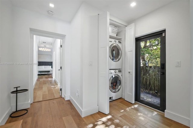 1060 NE 95th St, Miami Shores, FL 33138 - laundry room with stacked washer and clothes dryer and light wood-style flooring