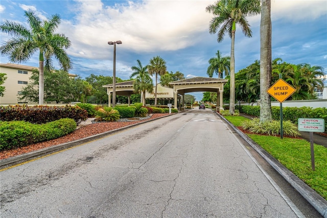 2006 Granada Unit J4, Coconut Creek, FL 33066 - view of asphalt road featuring traffic signs, curbs, and street lighting