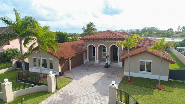 19686 SW 130th Ave Rd, Miami, FL 33177 - mediterranean / spanish home with an attached garage, decorative driveway, a tiled roof, and stucco siding