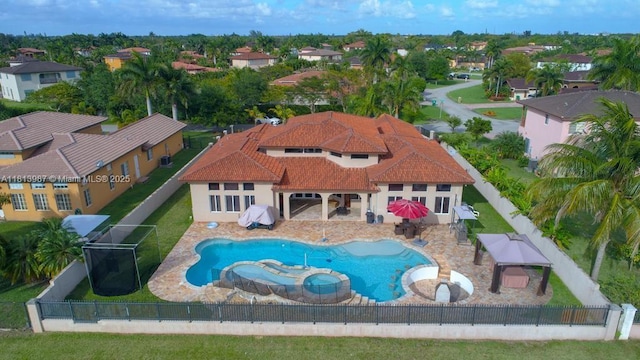 19686 SW 130th Ave Rd, Miami, FL 33177 - view of pool with a fenced backyard, a pool with connected hot tub, a residential view, a grill, and a patio