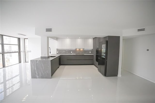 200 Leslie Dr Unit 314, Hallandale Beach, FL 33009 - kitchen featuring modern cabinets, a sink, white cabinets, a peninsula, and gray cabinetry