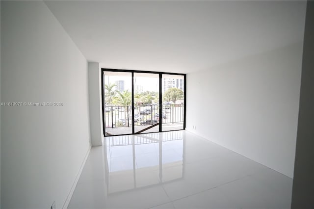 200 Leslie Dr Unit 314, Hallandale Beach, FL 33009 - spare room featuring expansive windows and tile patterned floors