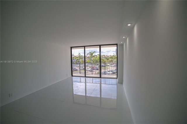 200 Leslie Dr Unit 314, Hallandale Beach, FL 33009 - empty room featuring a wall of windows and recessed lighting