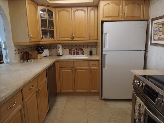 500 Three Islands Blvd Unit 613, Hallandale Beach, FL 33009 - kitchen featuring appliances with stainless steel finishes, a sink, light countertops, tasteful backsplash, and glass insert cabinets