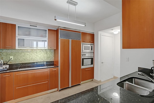 400 Alton Rd Unit 1409, Miami Beach, FL 33139 - kitchen with built in appliances, a sink, and brown cabinets