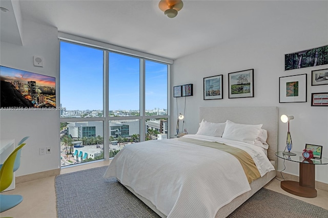 400 Alton Rd Unit 1409, Miami Beach, FL 33139 - bedroom featuring expansive windows, multiple windows, and a city view