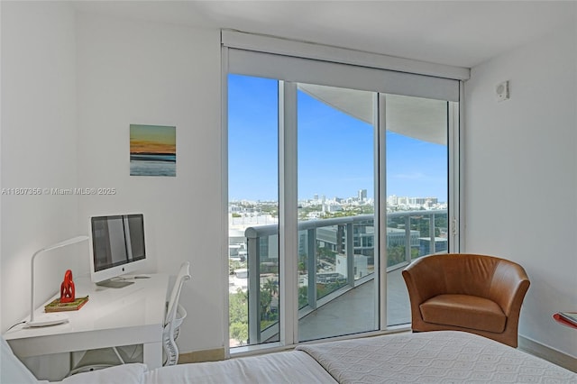 400 Alton Rd Unit 1409, Miami Beach, FL 33139 - bedroom featuring access to exterior, a wall of windows, and baseboards