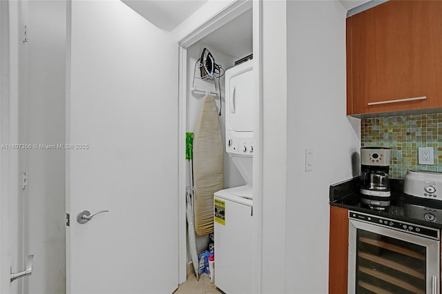 400 Alton Rd Unit 1409, Miami Beach, FL 33139 - washroom featuring stacked washing machine and dryer, beverage cooler, and light tile patterned floors