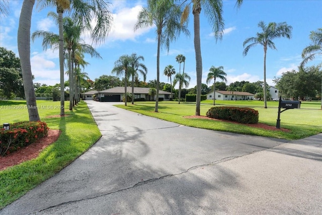 3030 SW 117th Ave, Davie, FL 33330 - view of home's community featuring a lawn, asphalt driveway, and a garage