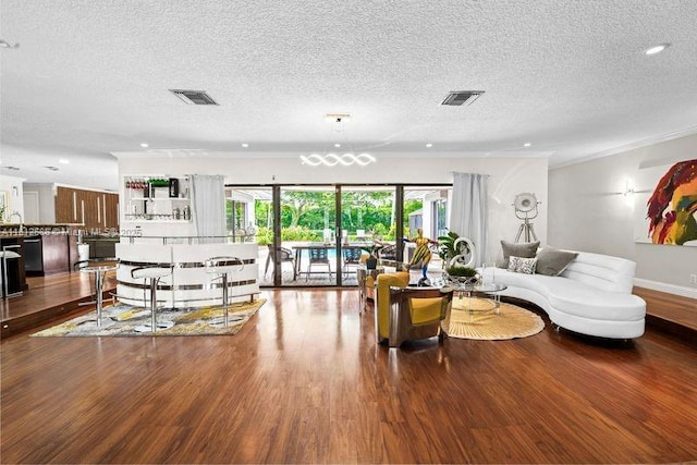 3030 SW 117th Ave, Davie, FL 33330 - living area with wood finished floors, a textured ceiling, ornamental molding, recessed lighting, and a chandelier