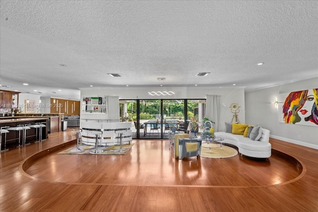 3030 SW 117th Ave, Davie, FL 33330 - living room with wood finished floors, a textured ceiling, recessed lighting, and baseboards
