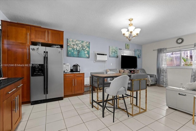 3030 SW 117th Ave, Davie, FL 33330 - kitchen with stainless steel refrigerator with ice dispenser, open floor plan, a chandelier, brown cabinets, and a textured ceiling