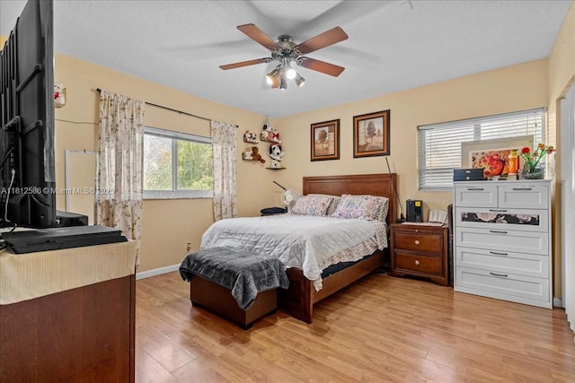 3030 SW 117th Ave, Davie, FL 33330 - bedroom with light wood finished floors, ceiling fan, and a textured ceiling