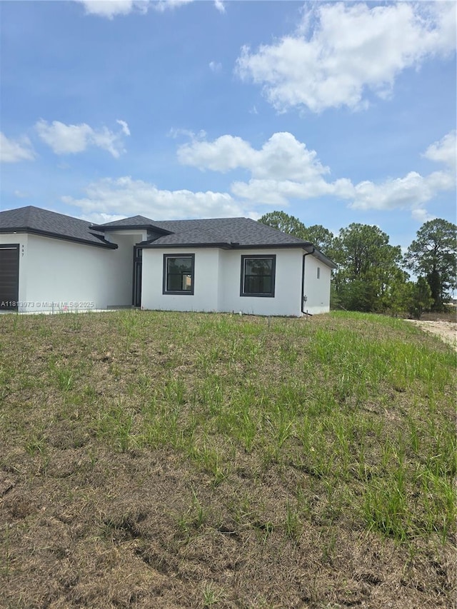 987 Edgerton, Lehigh Acres, FL 33974 - rear view of property featuring stucco siding