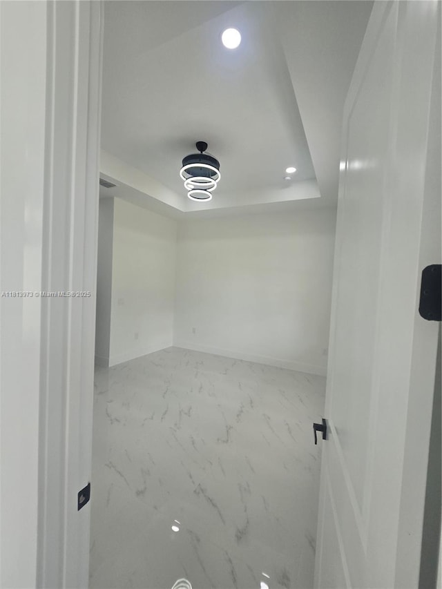 987 Edgerton, Lehigh Acres, FL 33974 - unfurnished room with a tray ceiling, recessed lighting, baseboards, and marble finish floors