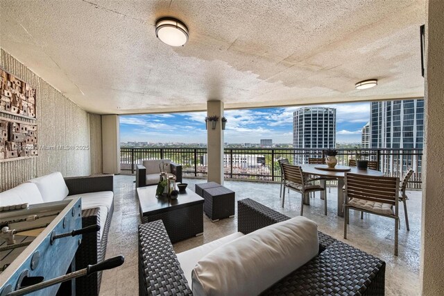 2901 S Bayshore Dr Unit 17G/H, Miami, FL 33133 - living room featuring floor to ceiling windows, a water view, and a textured ceiling