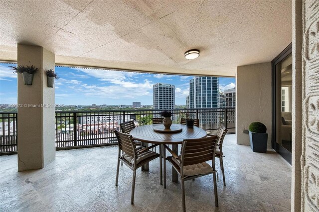 2901 S Bayshore Dr Unit 17G/H, Miami, FL 33133 - dining area featuring a view of city, floor to ceiling windows, and a textured ceiling