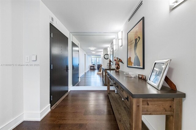 2901 S Bayshore Dr Unit 17G/H, Miami, FL 33133 - corridor with dark wood-style flooring and baseboards