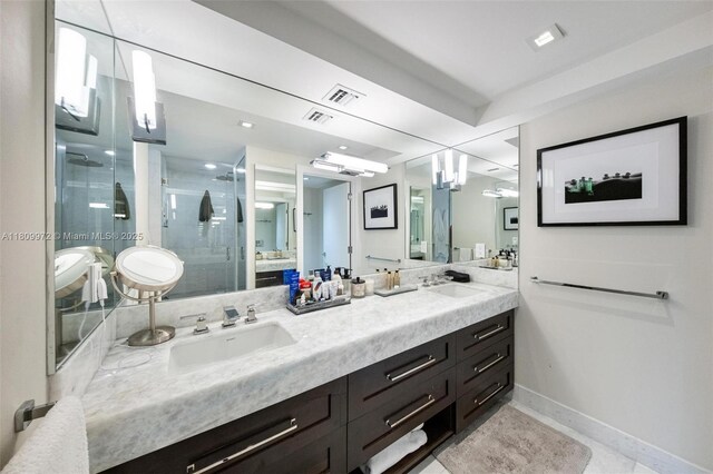 2901 S Bayshore Dr Unit 17G/H, Miami, FL 33133 - bathroom featuring double vanity, a stall shower, and baseboards
