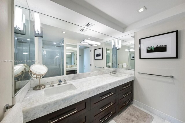 2901 S Bayshore Dr Unit 17G/H, Miami, FL 33133 - bathroom featuring double vanity, a stall shower, and baseboards