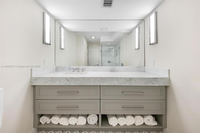 2901 S Bayshore Dr Unit 17G/H, Miami, FL 33133 - bathroom featuring vanity, a stall shower, and baseboards