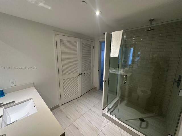 4010 S Ocean Dr Unit R1707, Hollywood, FL 33019 - bathroom with vanity, a stall shower, baseboards, and toilet