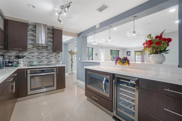3200 W 7th Ave, Hialeah, FL 33012 - kitchen featuring appliances with stainless steel finishes, wall chimney range hood, wine cooler, light countertops, and recessed lighting