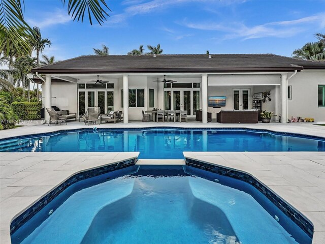 7448 SW 120th Ct, Miami, FL 33183 - view of swimming pool with french doors, ceiling fan, outdoor lounge area, a patio area, and a pool with connected hot tub