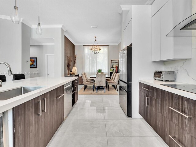 7448 SW 120th Ct, Miami, FL 33183 - kitchen featuring a sink, refrigerator, modern cabinets, ornamental molding, and wall chimney exhaust hood