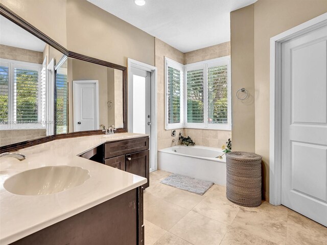 7448 SW 120th Ct, Miami, FL 33183 - bathroom with healthy amount of natural light, double vanity, a garden tub, and tile patterned flooring