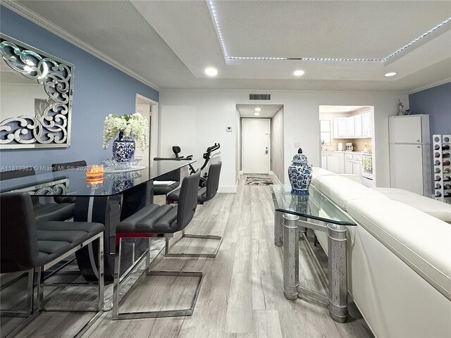 700 Lori Dr Unit 201, Palm Springs, FL 33461 - dining space featuring light wood-type flooring, a tray ceiling, recessed lighting, and crown molding