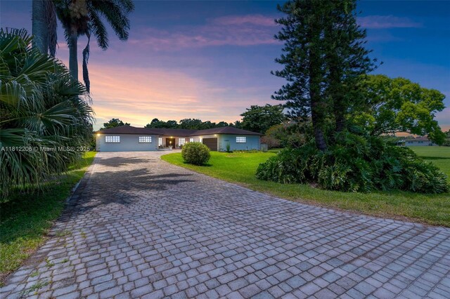 17550 SW 59th Ct, Southwest Ranches, FL 33331 - ranch-style house featuring decorative driveway and a front yard