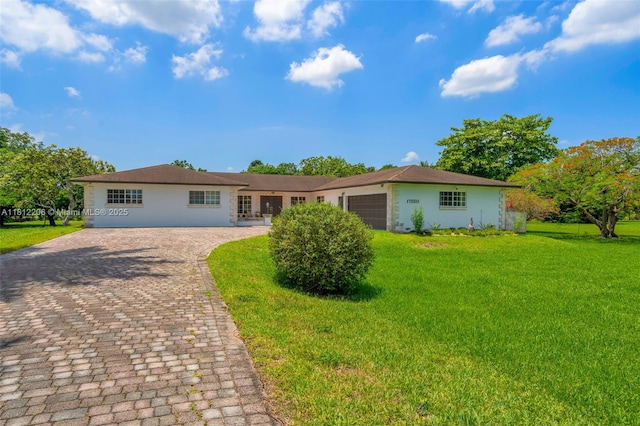 17550 SW 59th Ct, Southwest Ranches, FL 33331 - single story home featuring stucco siding, a front lawn, decorative driveway, and a garage