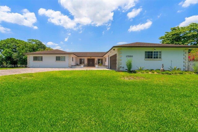 17550 SW 59th Ct, Southwest Ranches, FL 33331 - single story home with a garage, driveway, a front yard, and stucco siding