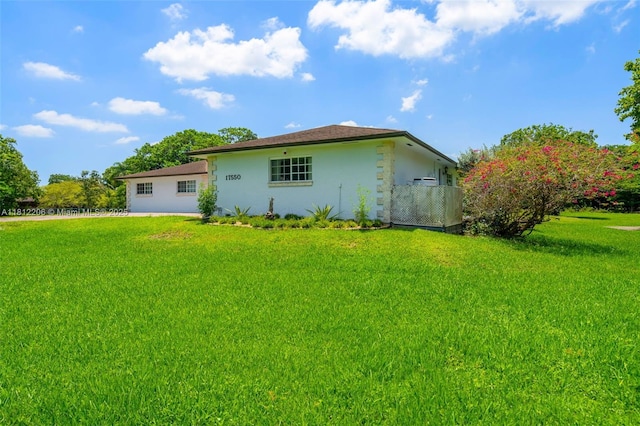 17550 SW 59th Ct, Southwest Ranches, FL 33331 - back of property featuring stucco siding and a yard