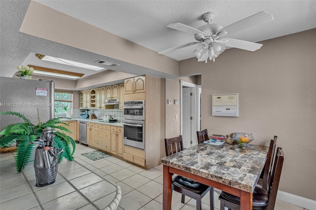 17550 SW 59th Ct, Southwest Ranches, FL 33331 - kitchen with stainless steel appliances, light brown cabinets, under cabinet range hood, a textured ceiling, and backsplash