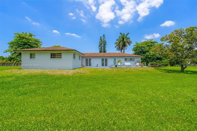17550 SW 59th Ct, Southwest Ranches, FL 33331 - back of property featuring french doors, a yard, and stucco siding